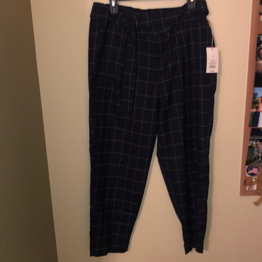 Women’s high waisted, navy blue, checkered trousers.